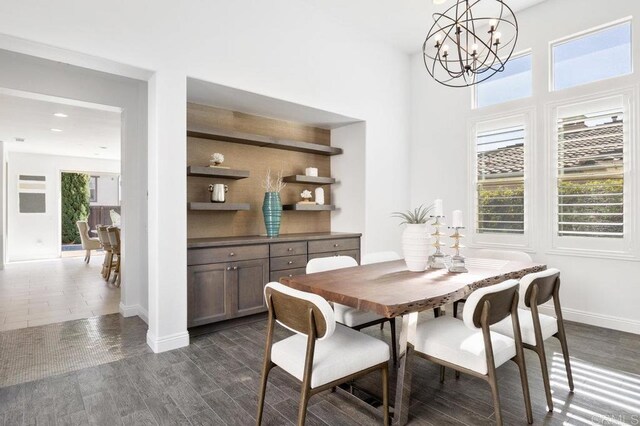 715 Blossom Rd, Encinitas, CA 92024 - dining space featuring a chandelier, dark wood finished floors, and a towering ceiling