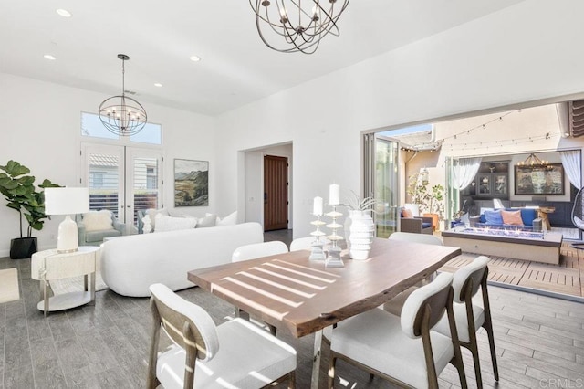 715 Blossom Rd, Encinitas, CA 92024 - dining area featuring a chandelier, wood finished floors, french doors, a towering ceiling, and recessed lighting