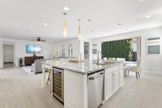 715 Blossom Rd, Encinitas, CA 92024 - kitchen featuring beverage cooler, stainless steel dishwasher, open floor plan, an island with sink, and healthy amount of natural light