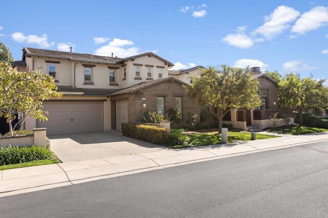 715 Blossom Rd, Encinitas, CA 92024 - view of front facade with a garage, driveway, and stucco siding