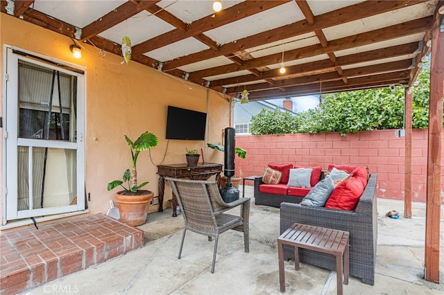 view of patio with an outdoor living space and fence