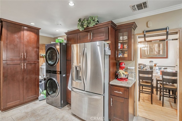 laundry room featuring recessed lighting, stacked washer / dryer, visible vents, and ornamental molding