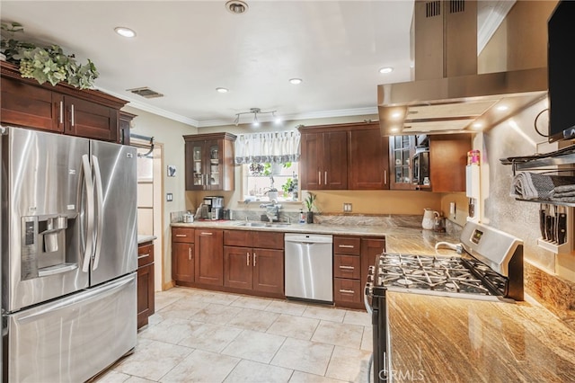 kitchen with crown molding, visible vents, appliances with stainless steel finishes, a sink, and island range hood