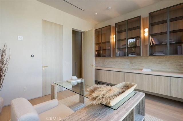 17177 Adlon Rd, Encino, CA 91436 - kitchen featuring light brown cabinetry, glass insert cabinets, light wood-style floors, modern cabinets, and light countertops