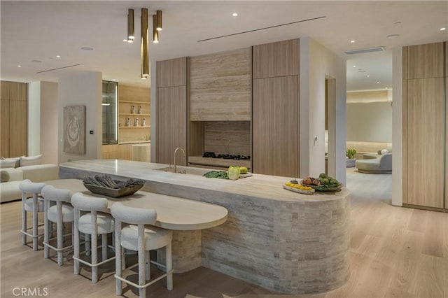 17177 Adlon Rd, Encino, CA 91436 - bar featuring a sink, recessed lighting, light wood finished floors, and visible vents