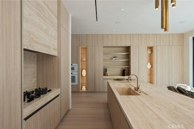17177 Adlon Rd, Encino, CA 91436 - bar featuring a sink, gas cooktop, and light wood-style floors