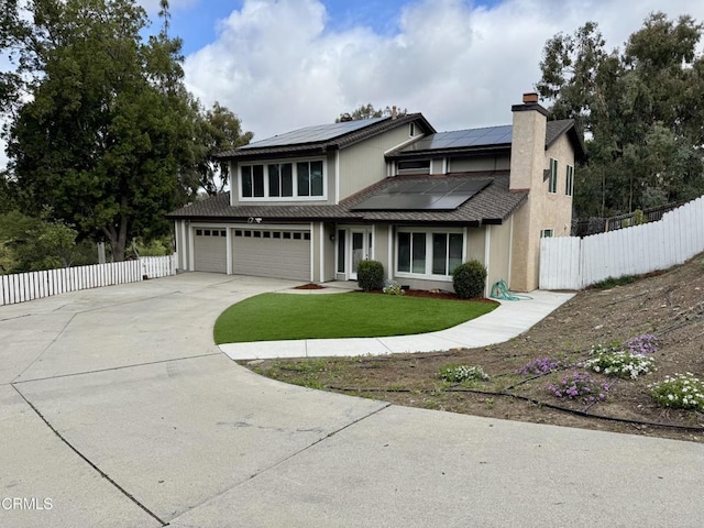 571 Citation Way, Newbury Park, CA 91320 - traditional-style house featuring fence, an attached garage, a front lawn, concrete driveway, and solar panels
