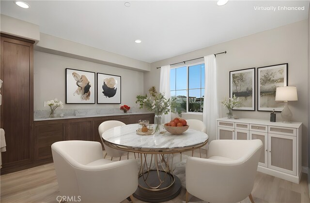 dining area with light wood-style floors and recessed lighting