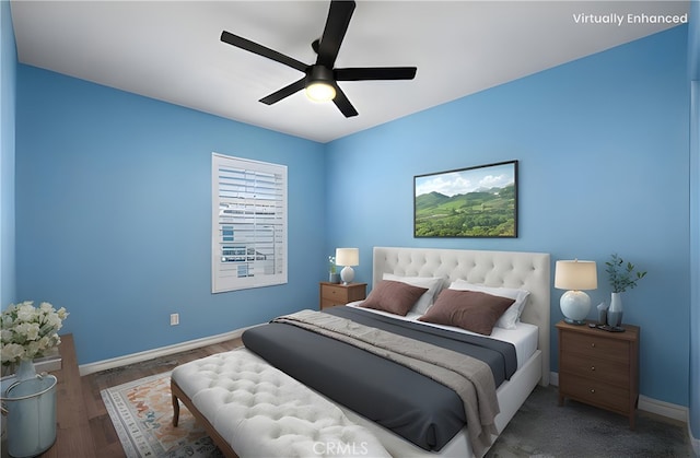 bedroom with wood finished floors, baseboards, and a ceiling fan