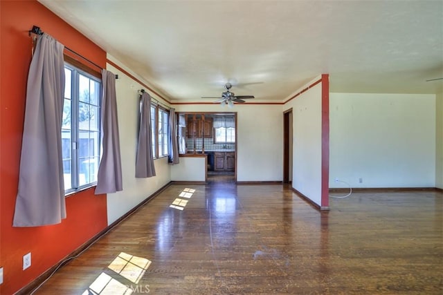 unfurnished living room with wood finished floors, ceiling fan, and baseboards