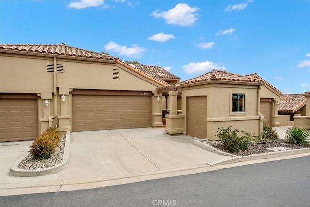 2344 Snowberry Ct, Avila Beach, CA 93424 - mediterranean / spanish home with stucco siding, an attached garage, a tiled roof, and driveway