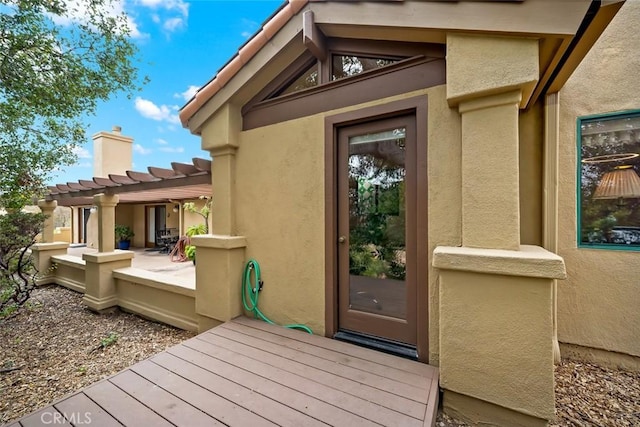 2344 Snowberry Ct, Avila Beach, CA 93424 - view of exterior entry with a tile roof, stucco siding, a patio, a pergola, and a chimney