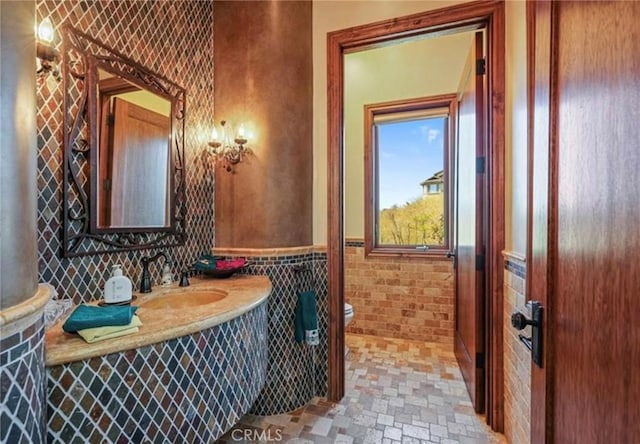 2695 Shady Ridge Ln, Diamond Bar, CA 91765 - bathroom featuring toilet, vanity, a wainscoted wall, and tile walls