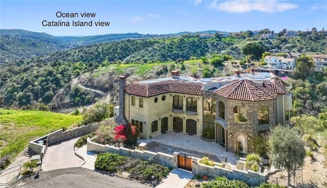 2695 Shady Ridge Ln, Diamond Bar, CA 91765 - back of house with a gate, a tile roof, stucco siding, and stone siding