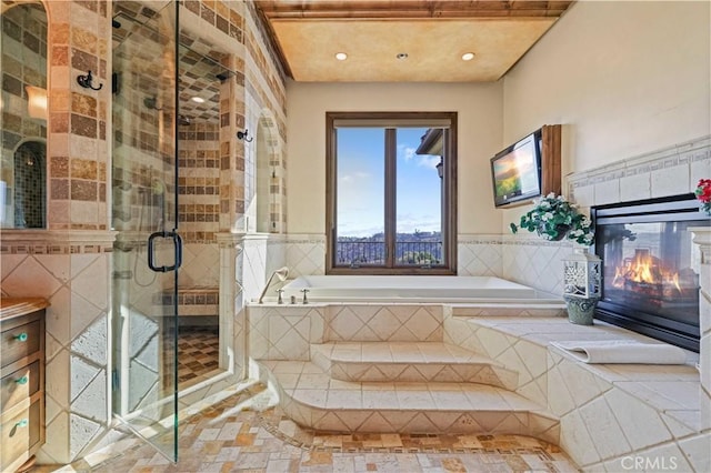 2695 Shady Ridge Ln, Diamond Bar, CA 91765 - bathroom featuring a garden tub, recessed lighting, a stall shower, a tile fireplace, and wainscoting