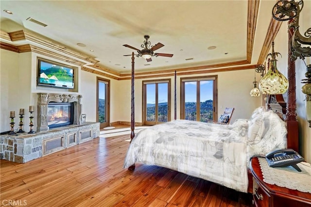 2695 Shady Ridge Ln, Diamond Bar, CA 91765 - bedroom with a glass covered fireplace, crown molding, wood-type flooring, access to exterior, and baseboards