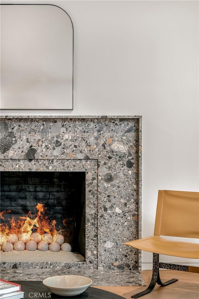 interior details with a fireplace and wood finished floors