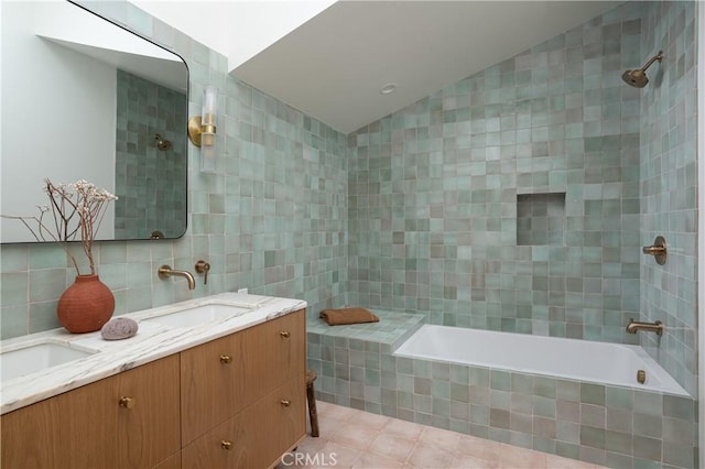 full bath with tiled shower / bath combo, double vanity, tile walls, and a sink