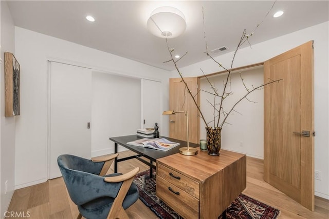 home office featuring baseboards, visible vents, recessed lighting, and light wood-style floors