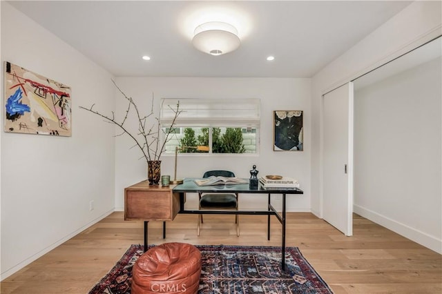 office featuring baseboards, wood finished floors, and recessed lighting