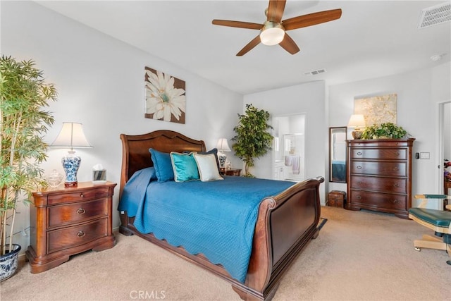 carpeted bedroom featuring connected bathroom, visible vents, and ceiling fan