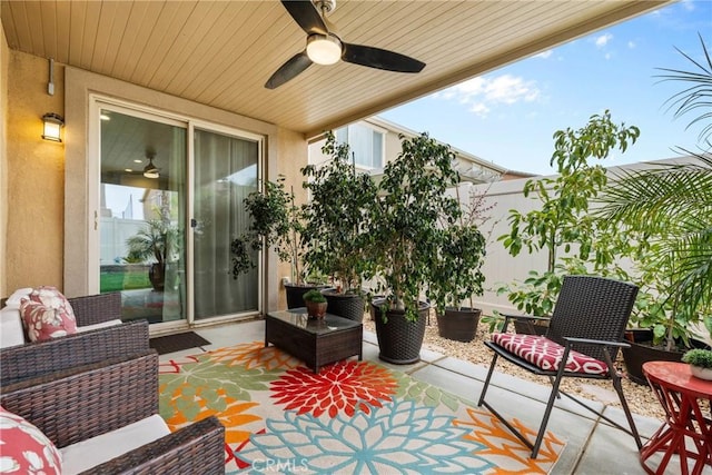 view of patio with fence and a ceiling fan