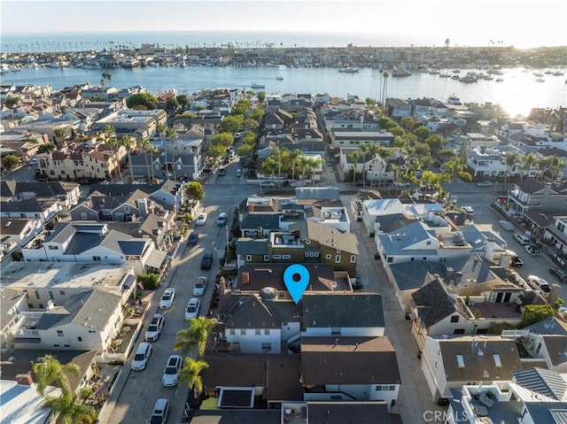 birds eye view of property with a water view and a residential view