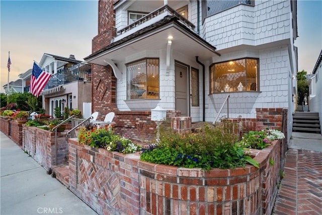 view of exterior entry featuring brick siding