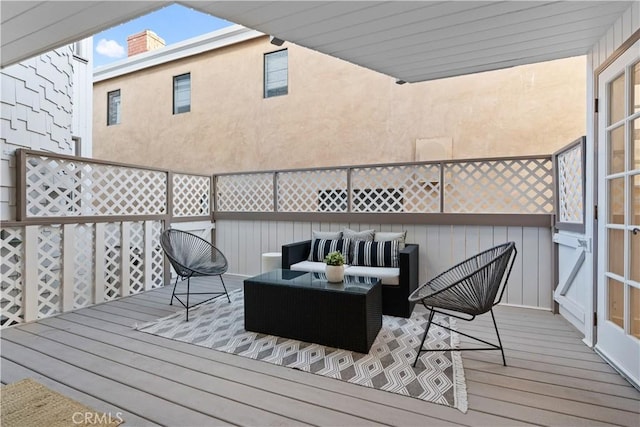 wooden terrace with an outdoor hangout area
