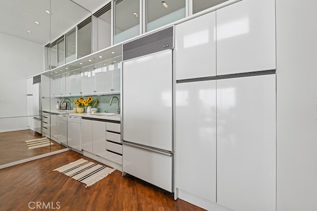 6 Voyage St Unit 204, Marina Del Rey, CA 90292 - kitchen with a sink, built in fridge, white cabinetry, dark wood finished floors, and a high ceiling