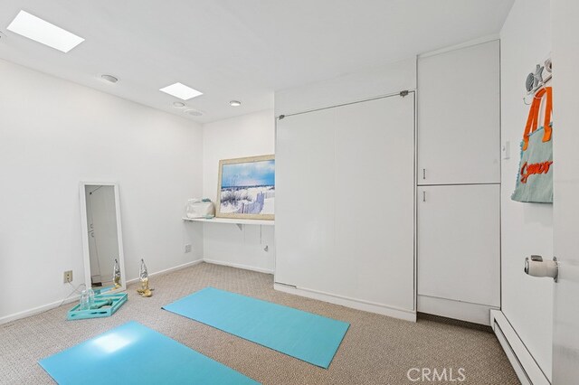 6 Voyage St Unit 204, Marina Del Rey, CA 90292 - workout room featuring carpet, a baseboard radiator, baseboards, and a skylight