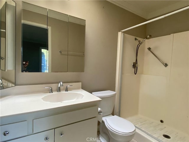 bathroom with toilet, vanity, and a shower stall