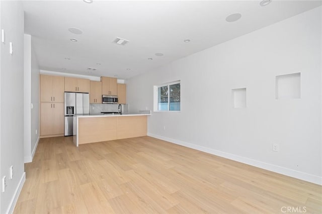 4641 W 130th St, Hawthorne, CA 90250 - kitchen featuring appliances with stainless steel finishes, light brown cabinets, light wood-style floors, light countertops, and baseboards