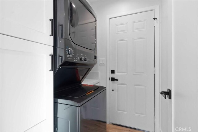 4641 W 130th St, Hawthorne, CA 90250 - washroom featuring stacked washing machine and dryer and wood finished floors