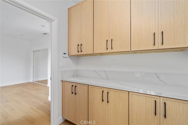 4641 W 130th St, Hawthorne, CA 90250 - kitchen featuring light brown cabinetry, light wood-type flooring, light stone countertops, and baseboards