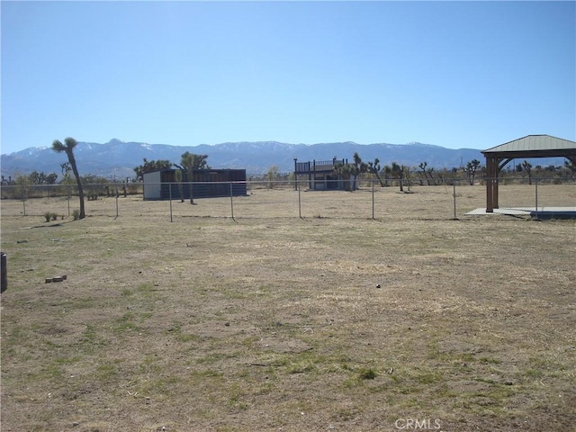 view of yard with a mountain view, a gazebo, and fence