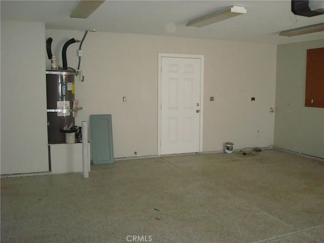 garage with strapped water heater and a garage door opener