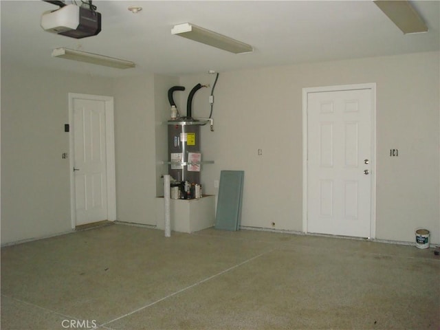 garage featuring electric water heater and a garage door opener