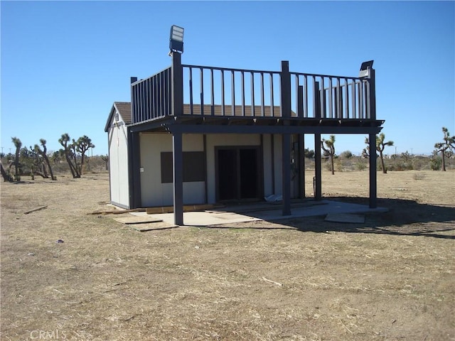 back of property featuring a wooden deck