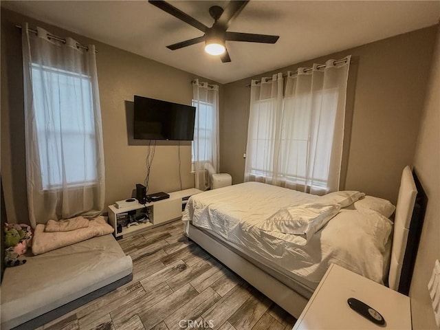 bedroom with wood finish floors and a ceiling fan