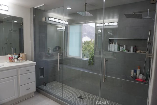 bathroom featuring a stall shower and vanity