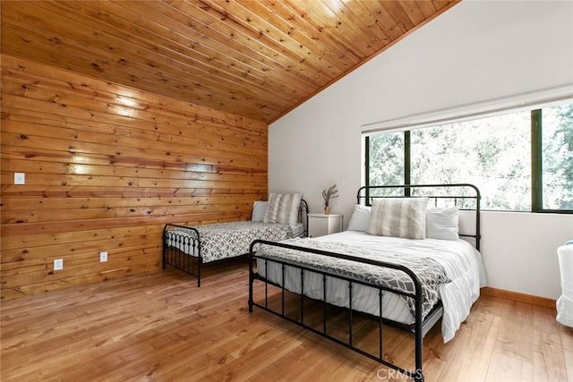 bedroom featuring lofted ceiling, multiple windows, wood ceiling, and wood-type flooring