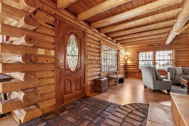 entrance foyer featuring beamed ceiling, wooden ceiling, log walls, and dark wood-style flooring