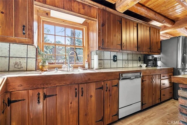 kitchen with light countertops, beamed ceiling, dishwasher, tasteful backsplash, and brown cabinetry