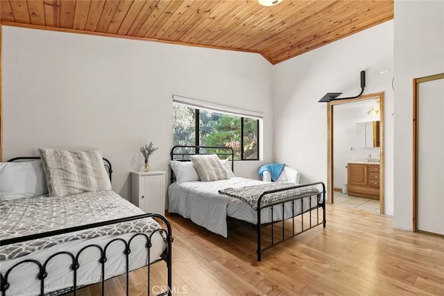 bedroom with ensuite bathroom, lofted ceiling, a sink, light wood-style floors, and wood ceiling