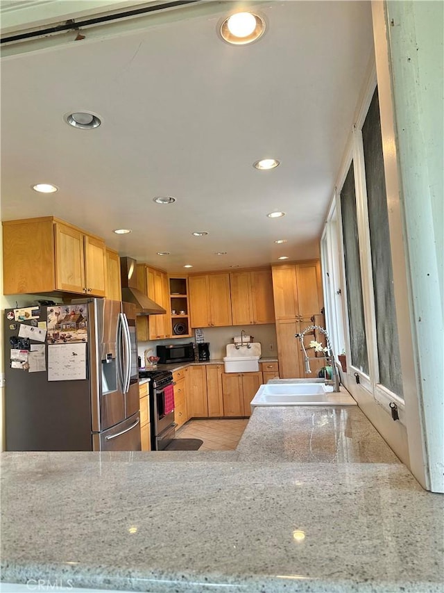 kitchen with a sink, appliances with stainless steel finishes, recessed lighting, and wall chimney exhaust hood