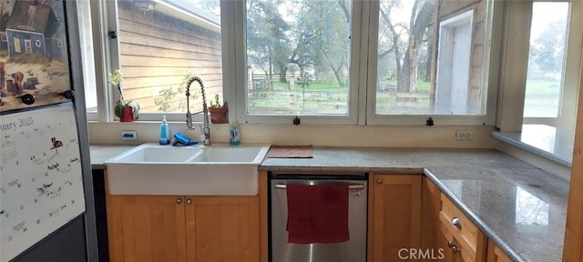 kitchen featuring a sink, stainless steel dishwasher, and brown cabinets
