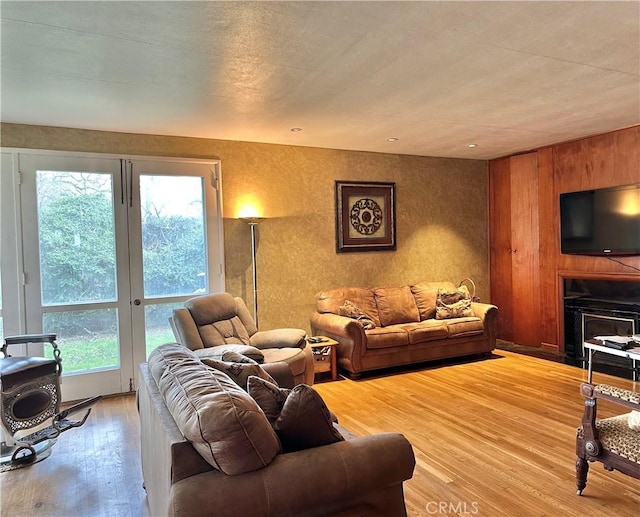 living room featuring a fireplace and light wood-style flooring