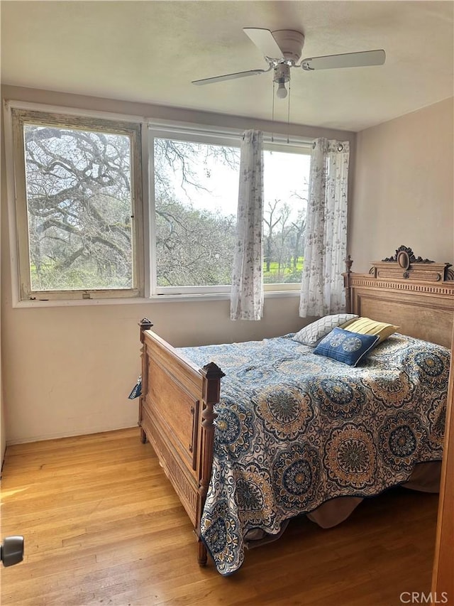 bedroom featuring a ceiling fan and wood finished floors