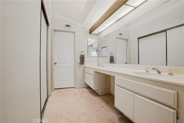 25301 Pine Creek Ln, Wilmington, CA 90744 - bathroom with double vanity and lofted ceiling